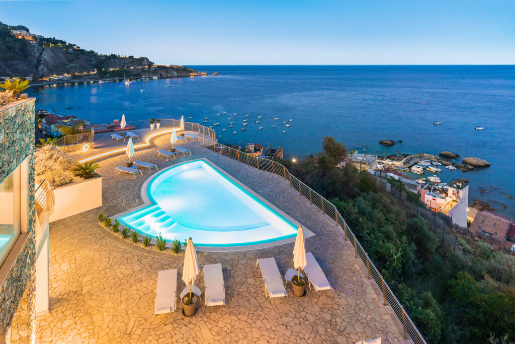 Villa Hera, the outside is being lit up and there is a gorgeous sea view.