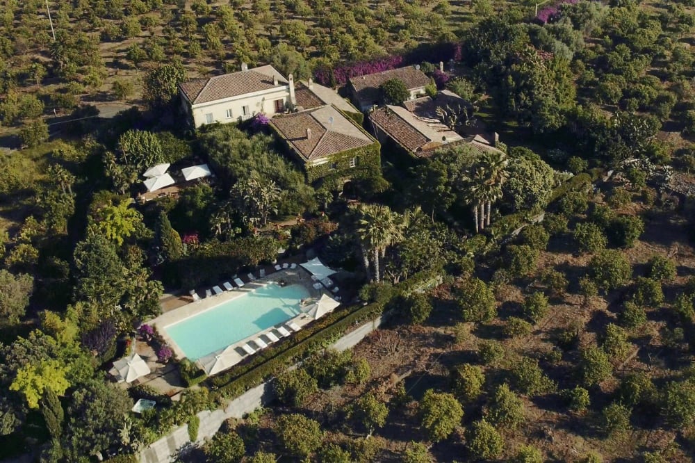 Drone camera shot of the villa with the private pool and surrounding forest