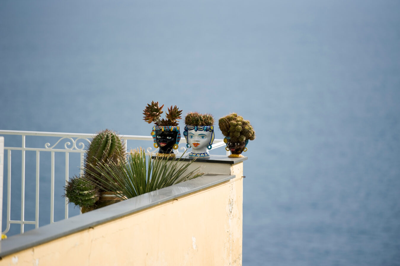 Moor's Heads (Testa Di Moro) on a wall by the sea.